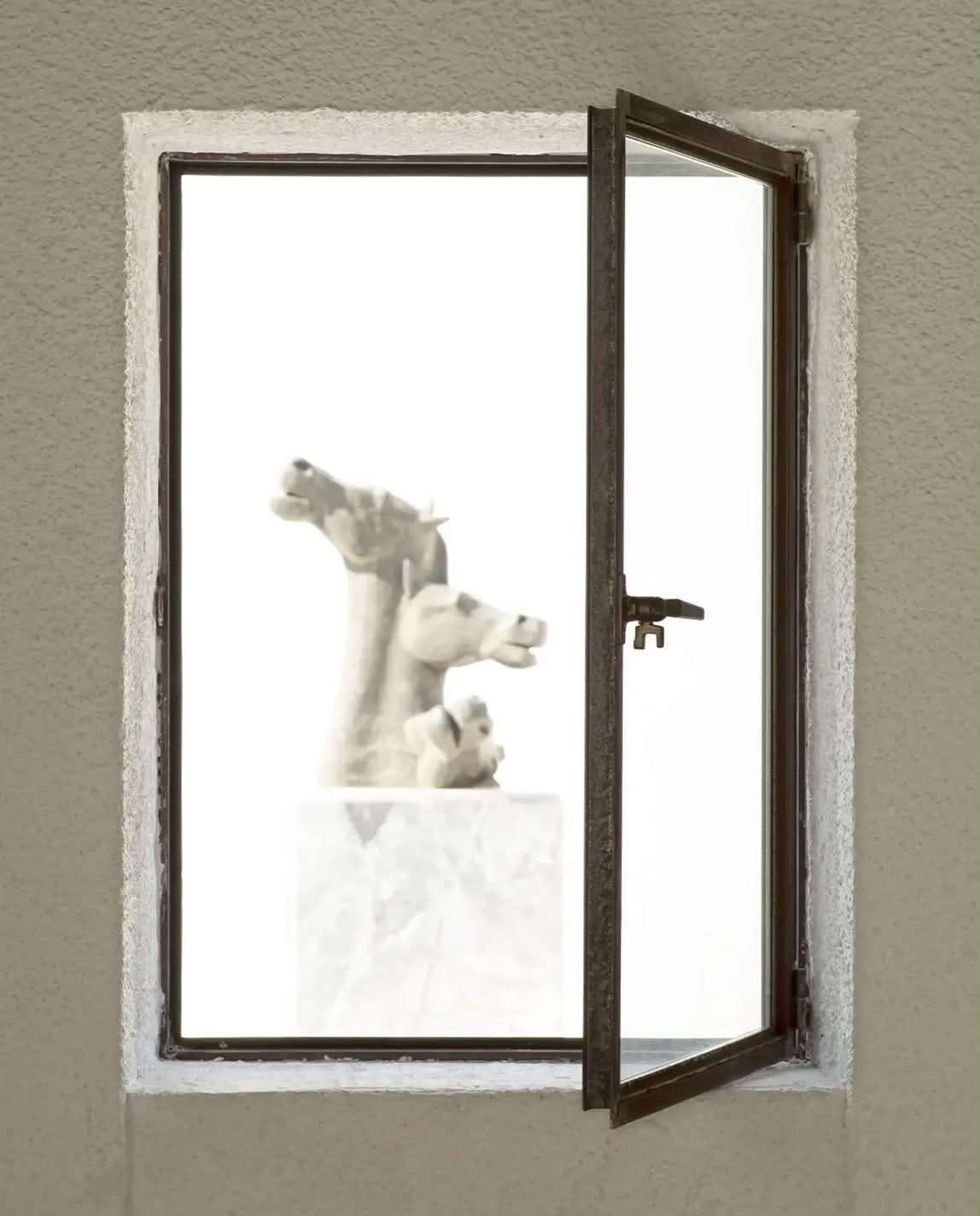 A sculpture seen through an open window at Vorres Museum